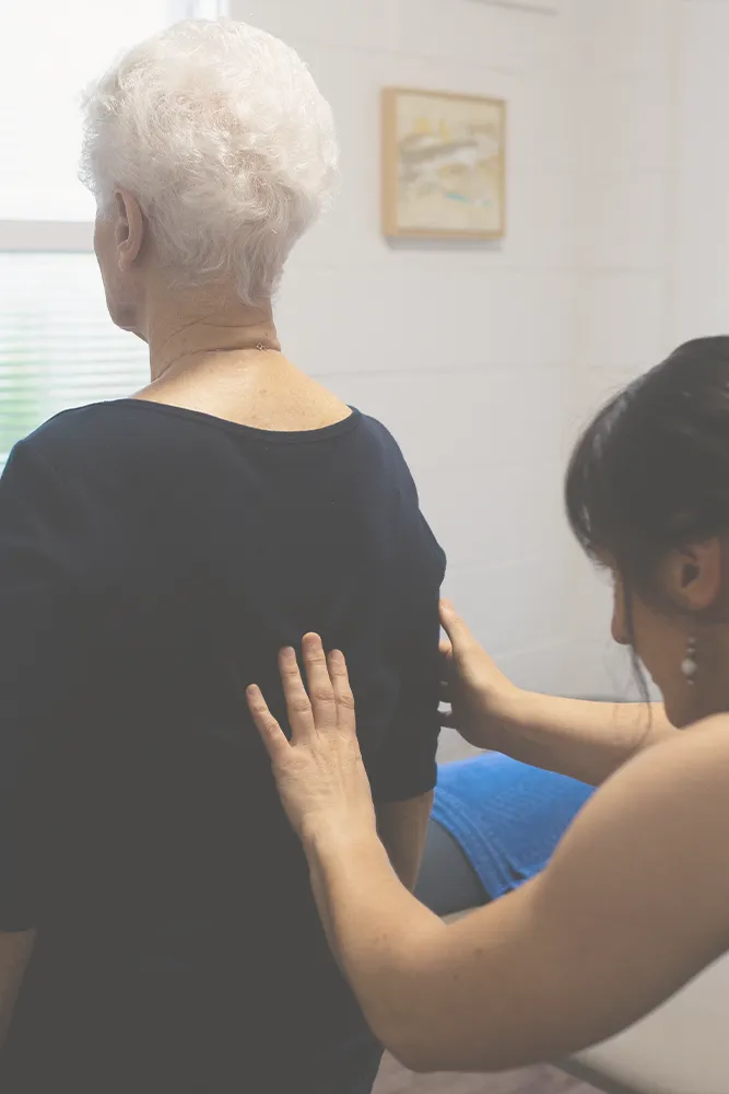 Patient learning pain management techniques with Brisbane osteopath